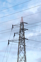 High voltage power transmission tower. Power tower with cloud background