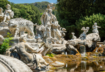 Group of marble statues decorating pond in a park in Italy