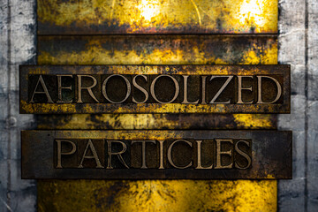 Aerosolized Particles text formed with real authentic typeset letters on vintage textured silver grunge copper and gold background
