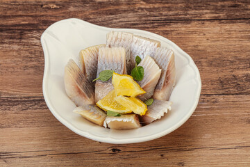 Herring fillet with sliced lemon