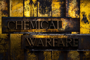 Chemical Warfare text formed with real authentic typeset letters on vintage textured silver grunge copper and gold background