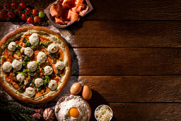 Brazilian pizza with salmon, leek and cream cheese. top view on wood background, close up. Traditional Brazilian Pizza