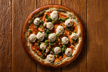 Brazilian pizza with salmon, leek and cream cheese. top view on wood background, close up. Traditional Brazilian Pizza