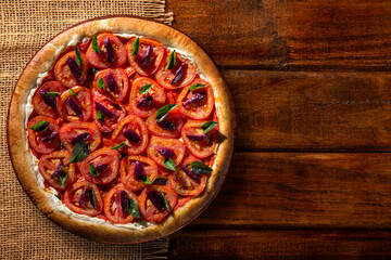 Pizza with tomato, olive and basil. Top view on wood background, close up. Traditional Brazilian Pizza