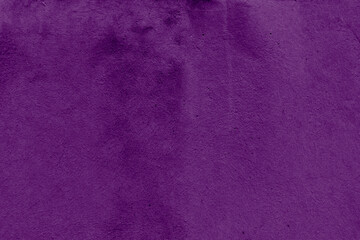 Texture of a painted wall. Cement wall violet color background. Wall with bumps 