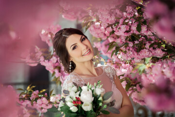 Obraz na płótnie Canvas beautiful bride in sakura blossom