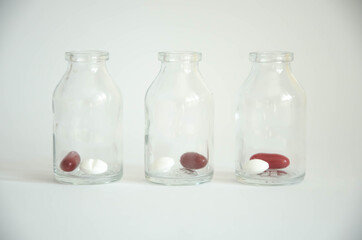  multi-colored pills lie in a bottle. medical supplies. medicines. disease treatment.