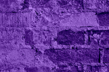 Closeup shot of wall of old purple bricks with crack cement
