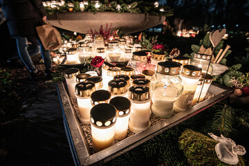 Grave candles on a cemetery on all saints eve.
