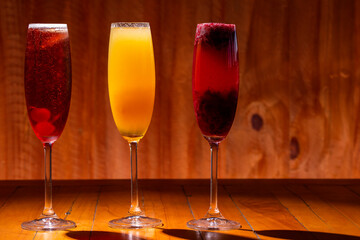 Kir royal, imperial and bellini cocktail on wood background