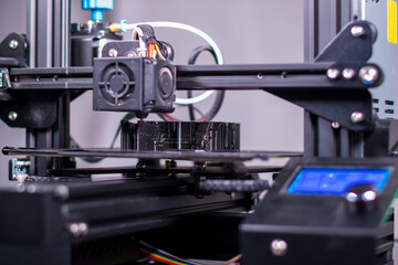 Fototapeta na wymiar 3D plastic printer during work in a factory three dimensional printing. Close-up detail.