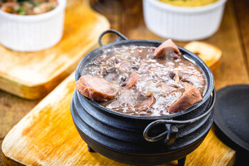 small portion of feijoada, smoky and hot. Typical Brazilian food.