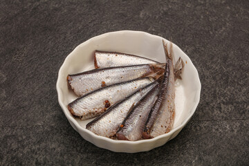Anchovies in the bowl served basil leaves