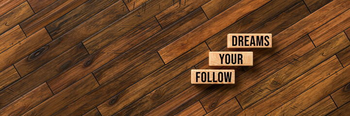 cubes with message FOLLOW YOUR DREAMS on wooden background