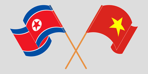 Crossed and waving flags of North Korea and Vietnam