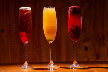 Kir royal, imperial and bellini cocktail on wood background