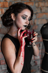 A brunette girl with creative make-up looks through black lace and shows different emotions. halloween concept