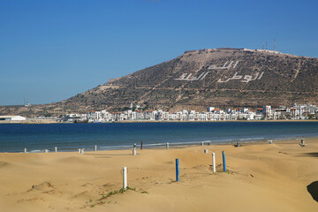 beach of Agadir Morocco, name of the mountain Oufellah, inscription: God, country, king