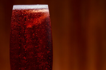 Kir royal cocktail with cherry on wood background
