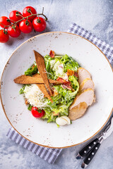 Classic caesar salad on a plate. Top view