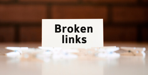 Broken links text of business concept on white list and with clothespins