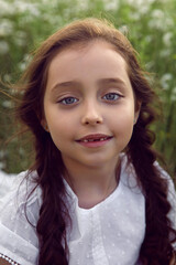 Fototapeta premium portrait girl child in a white dress standing