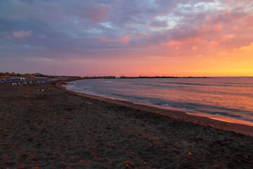 Sunrise at the beach In Monolithos on the island of Santorini in Greece.