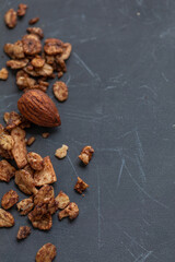 Nuts and granola on a dark grey background