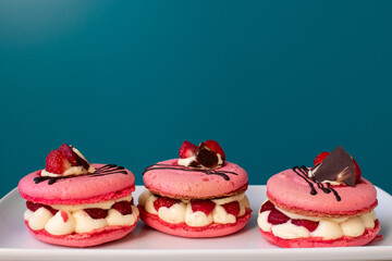 pink macarons stuffed with cream and strawberries. pastel colors