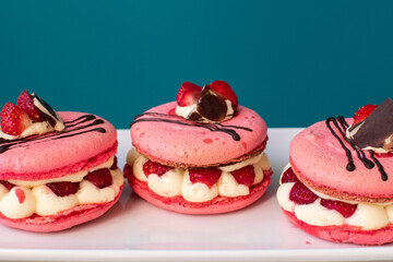 pink macarons stuffed with cream and strawberries. pastel colors