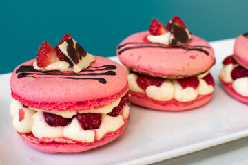 pink macarons stuffed with cream and strawberries. pastel colors