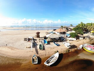 Boats in Buraquinho Beach with blue sky in Bahia, Brazil
