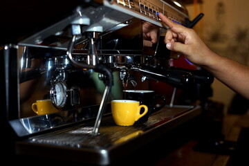 Fototapeta na wymiar Barista making coffee using a coffee maker