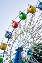 Ferris wheel on the background of blue sky