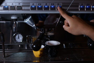 Barista making coffee using a coffee maker