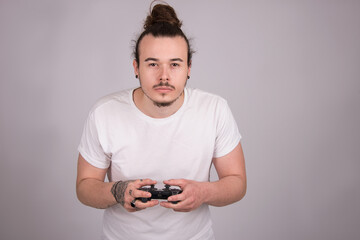   Caucasian young male  playing video game, adult holding console joystick, isolated on white