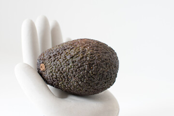 Whole avocado fruit isolated on a white background in close-up