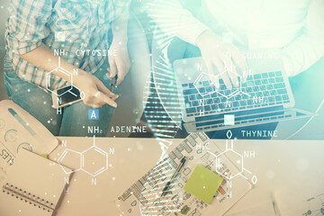 Double exposure of man and woman working together and DNA hologram drawing. Computer background. Medical education concept. Top View.