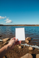 notebook in hand on nature background
