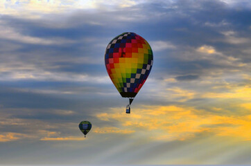 Colorful hot air Balloons float in a beautiful sunset sky