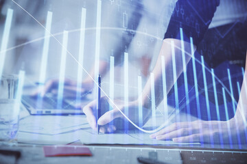 Multi exposure of woman hands typing on computer and financial chart hologram drawing. Stock market analysis concept.