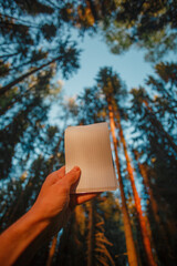 notebook in hand on nature background