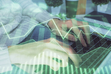 Double exposure of woman hands typing on computer and forex chart hologram drawing. Stock market invest concept.
