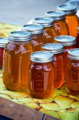  Local Golden honey in jars for sale at a farmers market