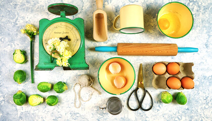 Vintage retro kitchenware and cooking ingredients creative layout overhead on white textured background. Flat lay concept.