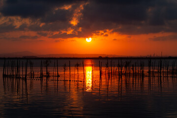 Fototapeta na wymiar Sunset over Albufera freshwater lagoon and estuary on the Gulf of Valencia coast, Spain