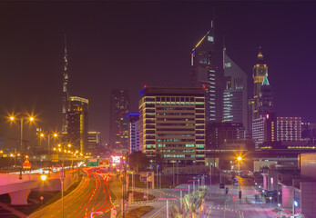 Fototapeta na wymiar DUBAI, UAE - MARCH 31, 2017: The nightly skyline of Downtown with the Burj Khalifa and Emirates Towers.