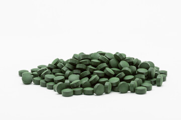 Spirulina seaweed tablets on white background