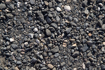 Grey gravel texture. Rustic road surface top view. Big gravel closeup photo for background. Rough gray stone road template