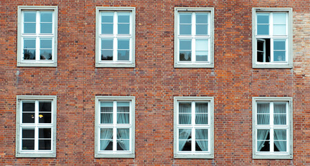 Fototapeta na wymiar White window on a red brick wall